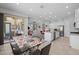 Open-concept dining room showcasing a glass table, bar seating, and a view of the kitchen and living area at 2750 W Pollack St, Phoenix, AZ 85041