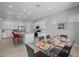 Spacious dining room features a glass table, white cabinets and stainless appliances in the open kitchen area at 2750 W Pollack St, Phoenix, AZ 85041