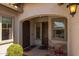 Inviting entryway with dual doors, decorative sconces, and a cozy seating area at 2750 W Pollack St, Phoenix, AZ 85041
