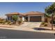 Attractive home exterior with a tile roof, a spacious driveway, and mature landscaping at 2750 W Pollack St, Phoenix, AZ 85041