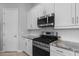 Well-equipped kitchen featuring stainless steel appliances, granite countertops and white cabinets at 2750 W Pollack St, Phoenix, AZ 85041