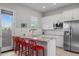 Bright white kitchen with granite countertops, stainless appliances and red barstools at 2750 W Pollack St, Phoenix, AZ 85041