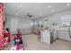 Bright open floor plan features modern kitchen and living room with tile floors and stainless steel appliances at 2750 W Pollack St, Phoenix, AZ 85041