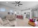 Bright open floor plan with tile floors, ceiling fan and white kitchen with granite countertops at 2750 W Pollack St, Phoenix, AZ 85041