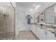 Elegant main bathroom featuring dual sinks, granite counters, and a glass-enclosed shower at 2750 W Pollack St, Phoenix, AZ 85041