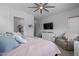 Spacious main bedroom with ample natural light, ceiling fan, seating area, and neutral decor at 2750 W Pollack St, Phoenix, AZ 85041