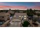 Stunning aerial view of a large two-story home with a three-car garage, desert landscaping, and a sparkling pool at 2881 E Estrella Ct, Gilbert, AZ 85296