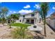 Expansive backyard features artificial turf, fire pit and desert landscaping, perfect for entertaining at 2881 E Estrella Ct, Gilbert, AZ 85296