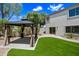 Relaxing backyard oasis with a gazebo, lush green grass, and beautiful desert landscaping at 2881 E Estrella Ct, Gilbert, AZ 85296