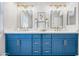 Modern bathroom with a double vanity, featuring stylish blue cabinets and gold fixtures at 2881 E Estrella Ct, Gilbert, AZ 85296