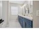 Elegant bathroom with double sinks, stylish blue cabinets, and modern fixtures at 2881 E Estrella Ct, Gilbert, AZ 85296