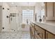 Well-lit bathroom featuring a walk-in shower, soaking tub, designer tile, and modern fixtures, offers a spa-like experience at 2881 E Estrella Ct, Gilbert, AZ 85296