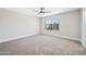 Bright bedroom with neutral walls, soft carpet, and a large window offering natural light at 2881 E Estrella Ct, Gilbert, AZ 85296