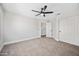 Inviting bedroom with plush carpeting, a ceiling fan, and a convenient closet for storage at 2881 E Estrella Ct, Gilbert, AZ 85296
