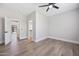 Spacious, airy bedroom with hardwood floors, ceiling fan, and multiple doors at 2881 E Estrella Ct, Gilbert, AZ 85296