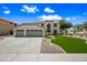Charming two-story home featuring a three-car garage, spacious driveway, manicured lawn, and desert landscaping at 2881 E Estrella Ct, Gilbert, AZ 85296