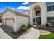 Charming two-story home showcasing a well-manicured lawn, desert landscaping, and a three-car garage at 2881 E Estrella Ct, Gilbert, AZ 85296