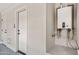 Garage interior highlighting a tankless water heater and access doors at 2881 E Estrella Ct, Gilbert, AZ 85296