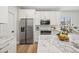 Elegant kitchen featuring stainless steel appliances, marble countertops, and custom cabinetry at 2881 E Estrella Ct, Gilbert, AZ 85296