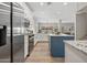 Modern kitchen with stainless steel appliances, granite countertops, and a blue kitchen island at 2881 E Estrella Ct, Gilbert, AZ 85296