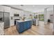 Bright kitchen boasts a blue island, granite countertops, white cabinetry, and stainless steel appliances at 2881 E Estrella Ct, Gilbert, AZ 85296