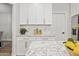 Bright kitchen with white cabinetry, marble countertops, gold hardware, and stylish decor at 2881 E Estrella Ct, Gilbert, AZ 85296