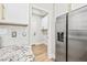 Modern kitchen with stainless steel appliances, white cabinets, and an adjoining laundry room at 2881 E Estrella Ct, Gilbert, AZ 85296