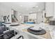 Bright kitchen with a marble countertop island, barstool seating, and modern fixtures at 2881 E Estrella Ct, Gilbert, AZ 85296