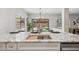 A gourmet kitchen featuring a large island with sink and faucet overlooking the backyard at 2881 E Estrella Ct, Gilbert, AZ 85296