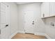 Well-organized laundry room with white cabinets, hardwood floors, and modern amenities at 2881 E Estrella Ct, Gilbert, AZ 85296