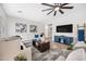 Open-concept living room with a large sectional, modern decor, and a ceiling fan at 2881 E Estrella Ct, Gilbert, AZ 85296