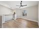Bright and airy loft space with hardwood floors, modern lighting, and a ceiling fan offers a flexible area at 2881 E Estrella Ct, Gilbert, AZ 85296