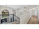 Open loft space with modern chandelier, black railing, and neutral colors at 2881 E Estrella Ct, Gilbert, AZ 85296