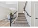 Carpeted staircase leading to the second floor with modern railing and adjacent dining area at 2881 E Estrella Ct, Gilbert, AZ 85296