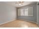 Bedroom with ceiling fan, shuttered window and wood floors at 3050 E Pontiac Dr, Phoenix, AZ 85050