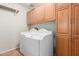 Bright laundry room features a full size washer and dryer and lots of cabinet space at 3050 E Pontiac Dr, Phoenix, AZ 85050