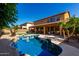 View of the sparkling backyard swimming pool, patio, synthetic lawn, and desert landscaping at 3080 E Andre Ave, Gilbert, AZ 85298