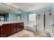 Bathroom featuring a bathtub, glass-door shower, and a spacious vanity with a large mirror at 3080 E Andre Ave, Gilbert, AZ 85298