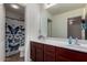 A well-lit bathroom with double sinks and a butterfly shower curtain at 3080 E Andre Ave, Gilbert, AZ 85298