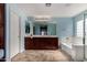 Spacious bathroom with double sinks, soaking tub, and plenty of natural light at 3080 E Andre Ave, Gilbert, AZ 85298