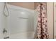 Bathtub and shower combination with a leaf-patterned shower curtain at 3080 E Andre Ave, Gilbert, AZ 85298