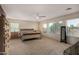Bright, carpeted bedroom with a ceiling fan, large windows, and natural light at 3080 E Andre Ave, Gilbert, AZ 85298