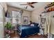 Cozy bedroom with a blue bed frame, decorated with toys and personal items throughout the room at 3080 E Andre Ave, Gilbert, AZ 85298