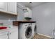 The laundry room features white cabinets, a utility sink, and modern LG washer and dryer units at 3080 E Andre Ave, Gilbert, AZ 85298