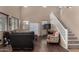 Inviting living room featuring hard wood floors, large windows, and a staircase to the second floor at 3080 E Andre Ave, Gilbert, AZ 85298