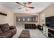 Open-concept living area with a brown sofa, ottoman, a ceiling fan, and open views of the second floor at 3080 E Andre Ave, Gilbert, AZ 85298