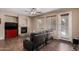Comfortable living room featuring a fireplace, hardwood floors, a ceiling fan, and plenty of natural light at 3080 E Andre Ave, Gilbert, AZ 85298