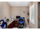 This home office features built-in cabinets, a comfortable chair, and natural light from the window at 3080 E Andre Ave, Gilbert, AZ 85298