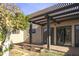 Charming backyard with a covered patio, desert landscaping, and a mature tree at 3345 E University Dr # 2, Mesa, AZ 85213