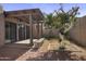 Cozy backyard with a covered patio, desert landscaping, and a mature tree at 3345 E University Dr # 2, Mesa, AZ 85213